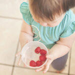 child with bowl of berries