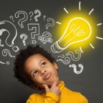 boy thinking with black background and light bulb