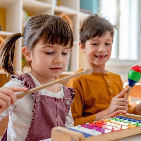 preschool children playing musical instruments in the classroom