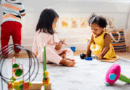 Two toddlers playing with toys on the floor