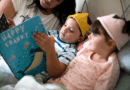 Mother and children reading a book in bed