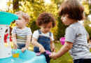 Toddlers play at a water table
