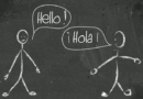 Chalkboard drawing of two people saying hello in English and Spanish