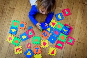child plays with letter blocks