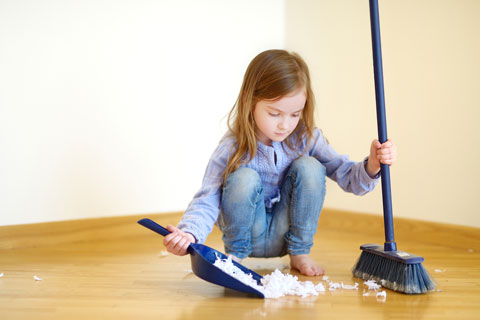 child with broom and dust pan