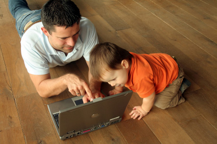 dad and child looking at laptop
