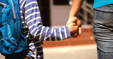 Child holding his mother's hand