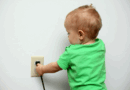 Child putting a cord in an outlet