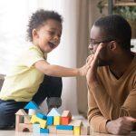 dad and child playing with blocks