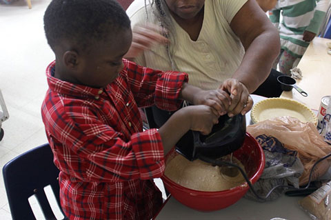 Figure 3. Children used tools for baking, with assistance.