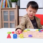 Child playing with letter blocks