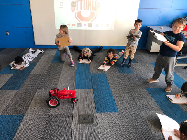 children with toy tractor