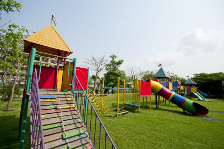 colorful outdoor playground with climbing equipment and slide